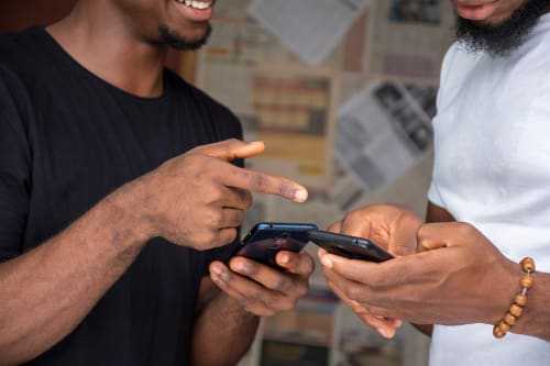 Two men using a phone