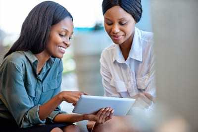 Two XENO ladies using a tablet